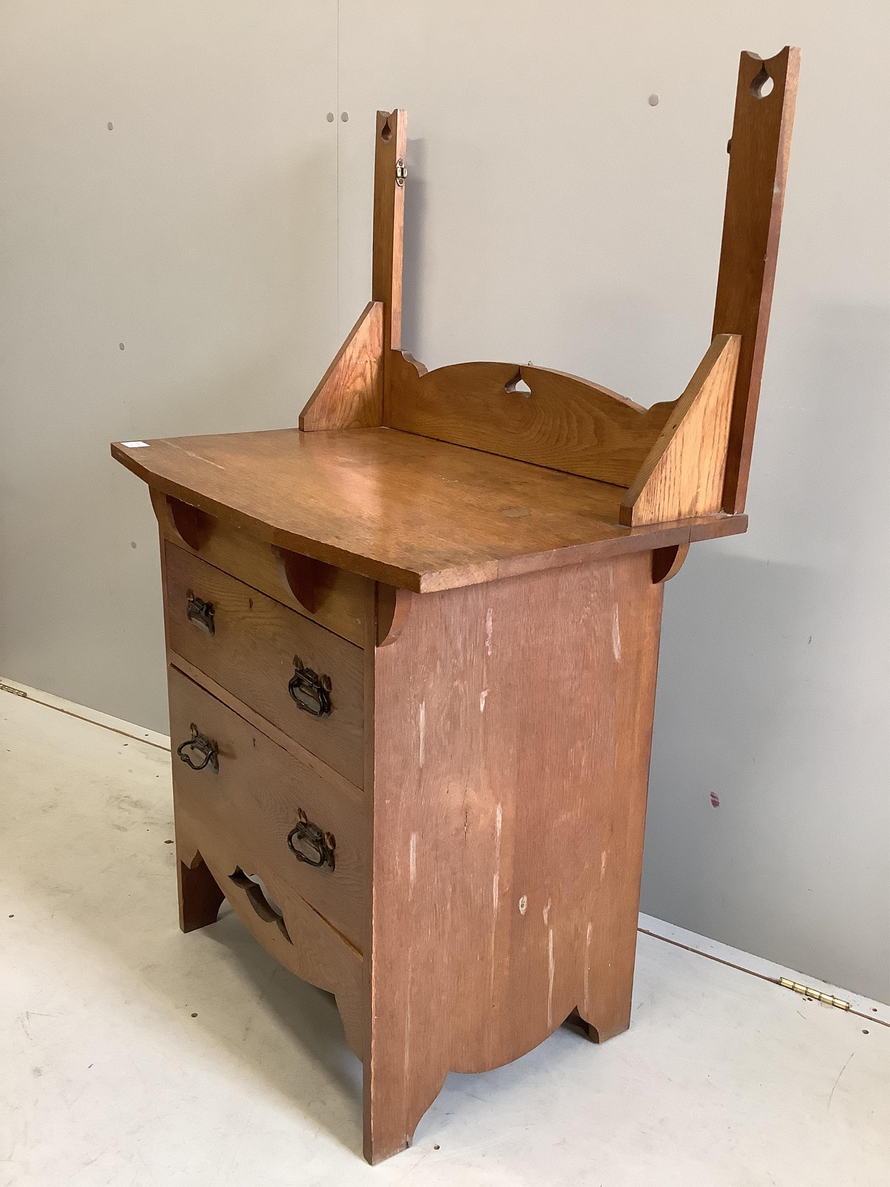 An Arts and Crafts oak dressing chest, (lacking mirror) width 84cm, depth 50cm, height 133cm